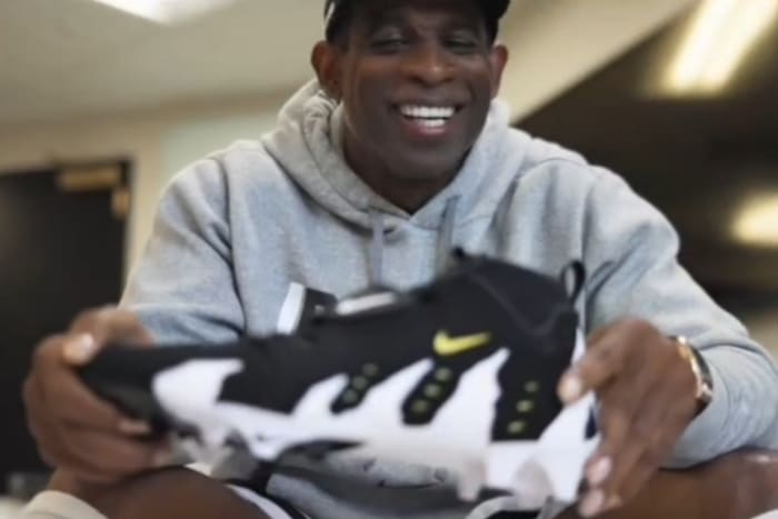 Deion Sanders holding Diamond Turf 3's for LeBron James